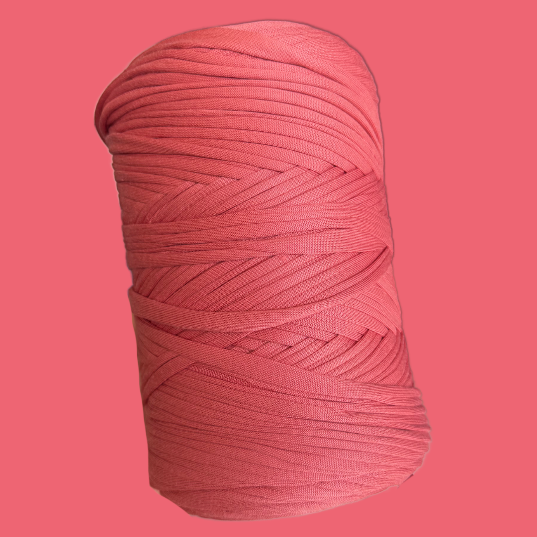 a ball of pink yarn on a pink background