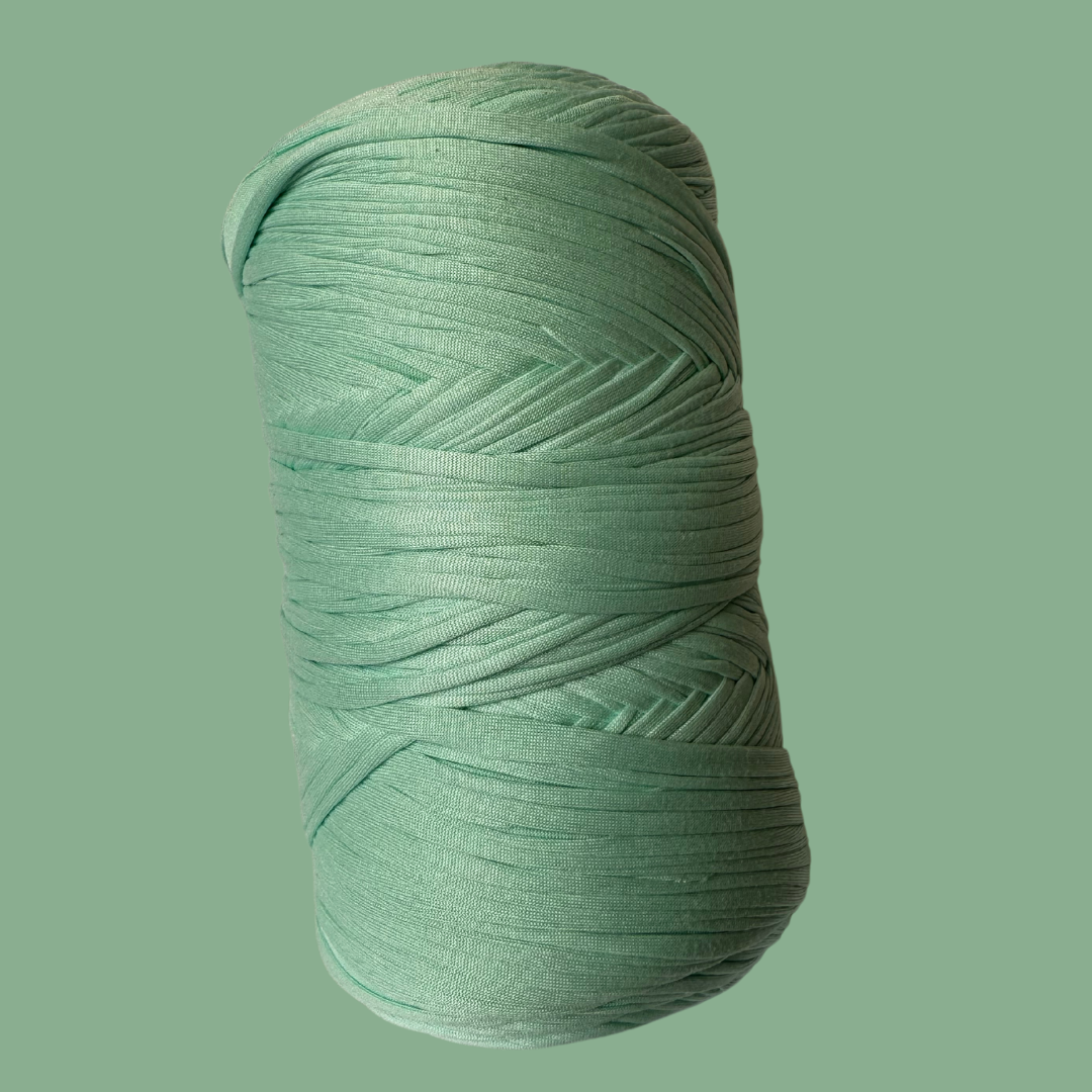 a green ball of yarn on a green background