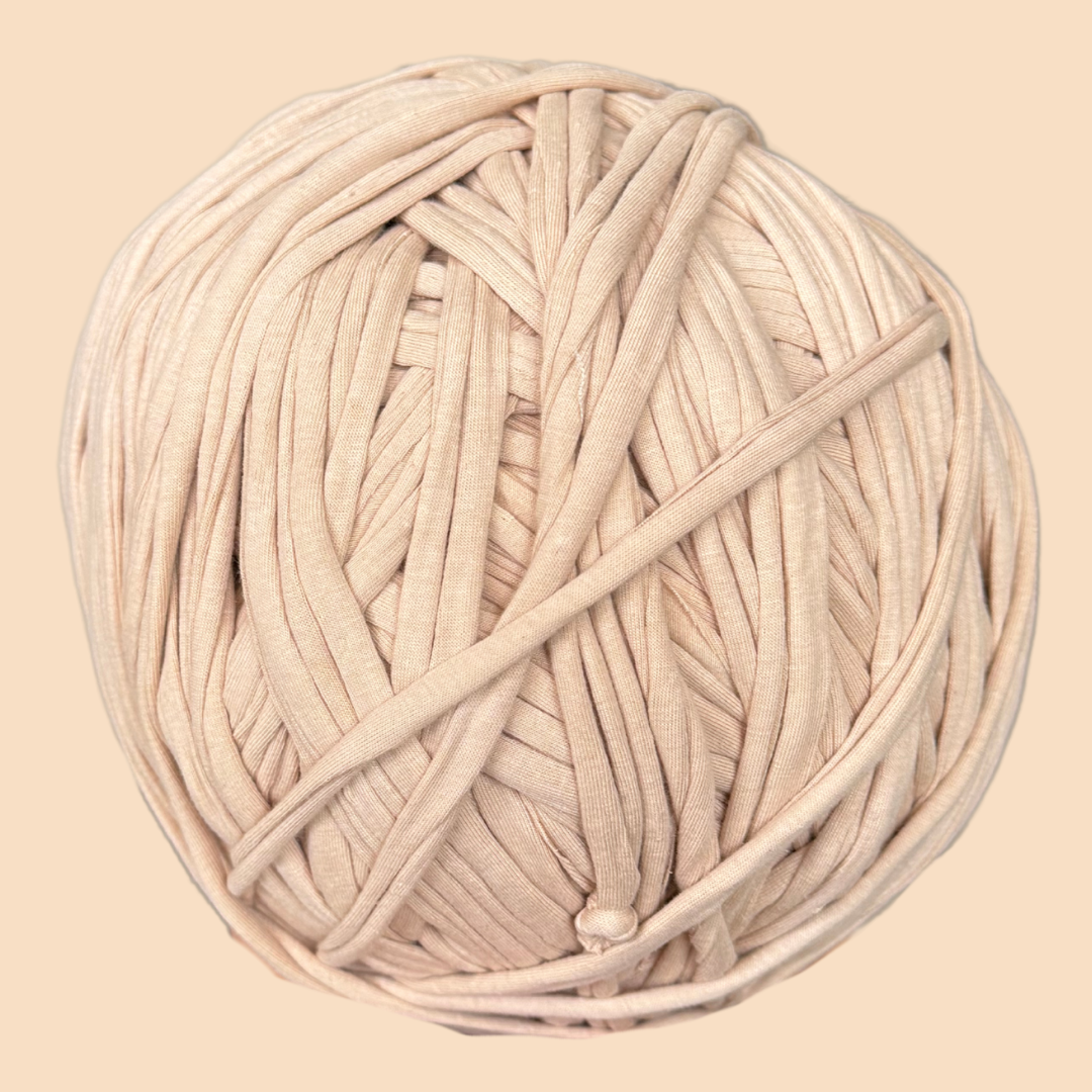 a ball of white yarn on a beige background