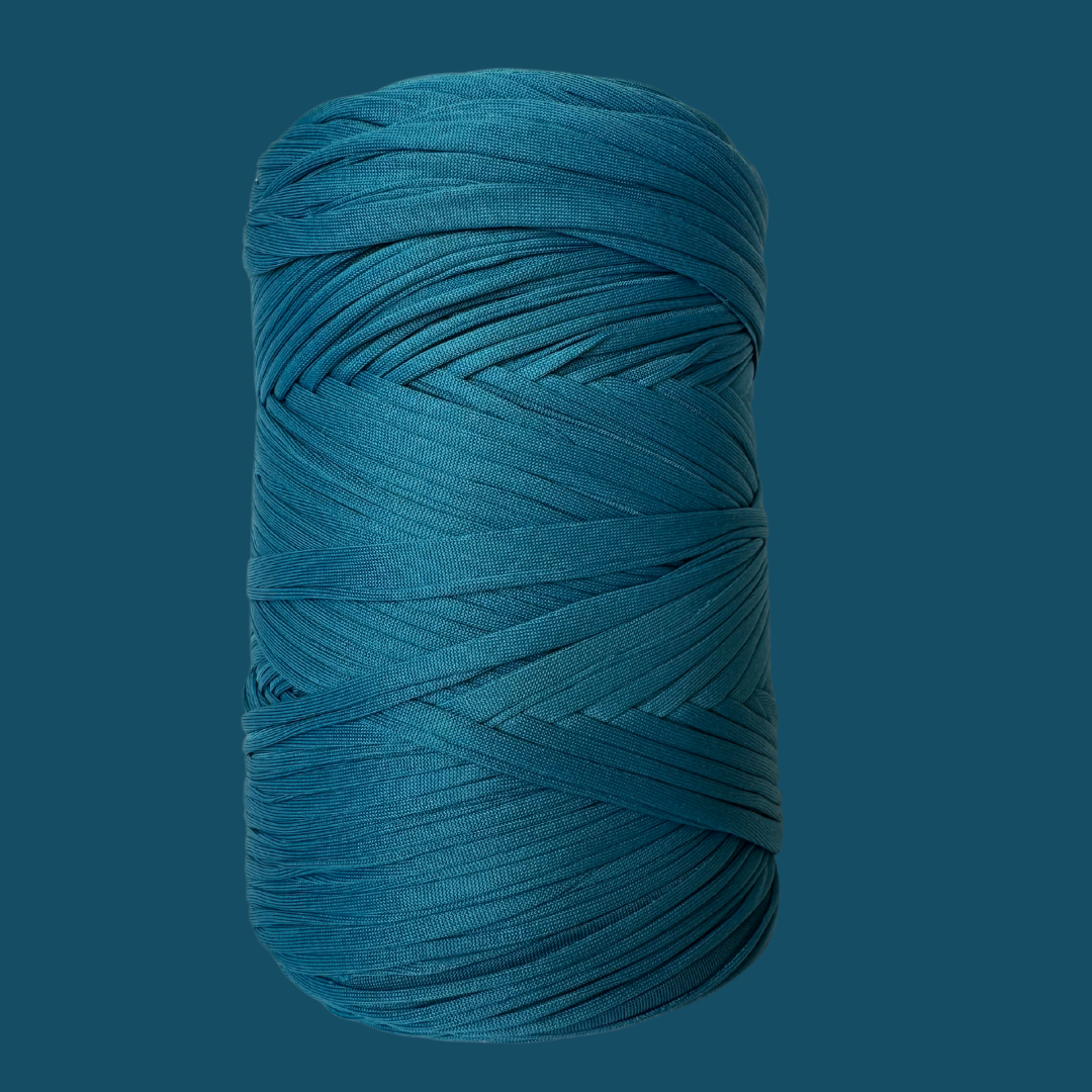 a roll of blue yarn on a blue background