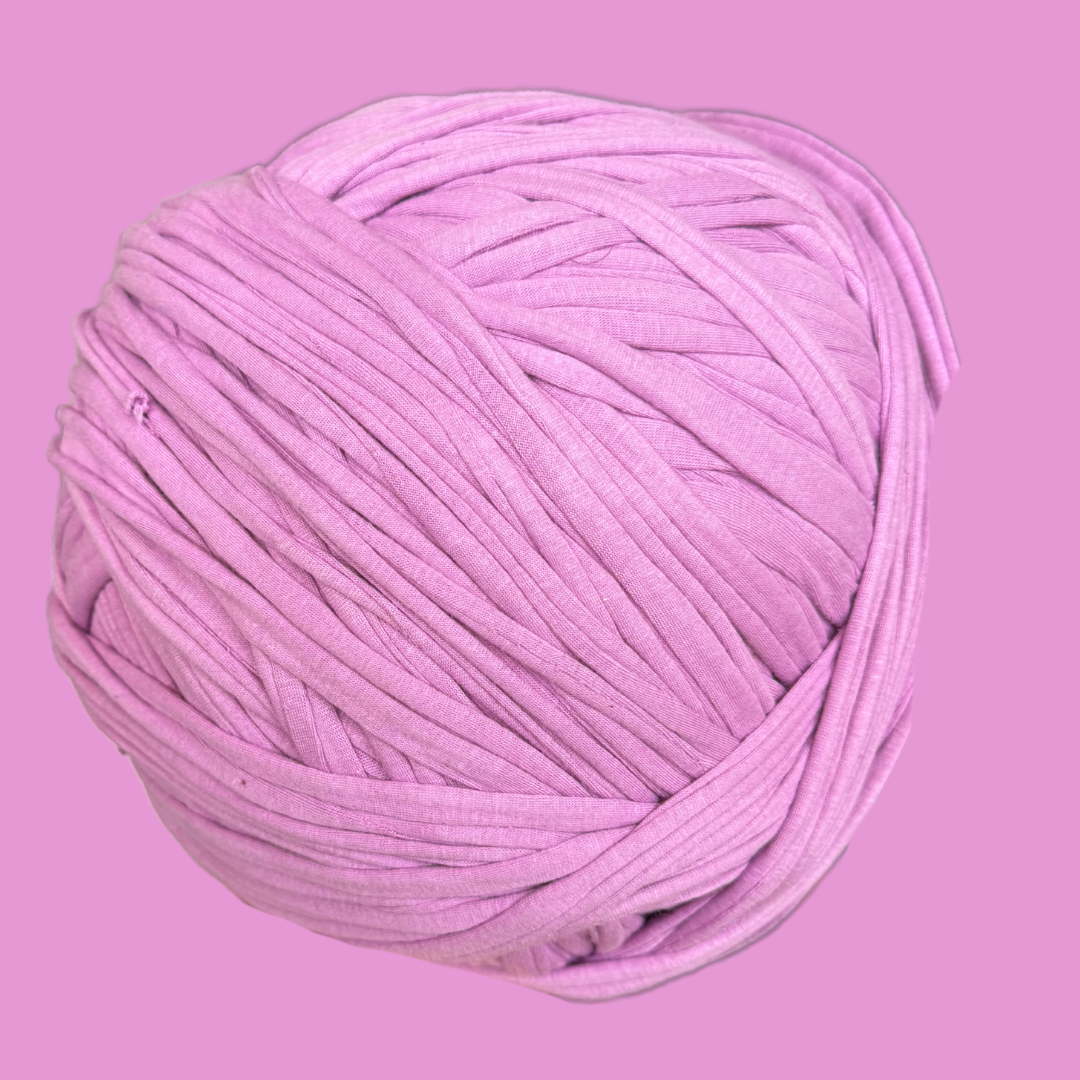 a ball of pink yarn on a pink background