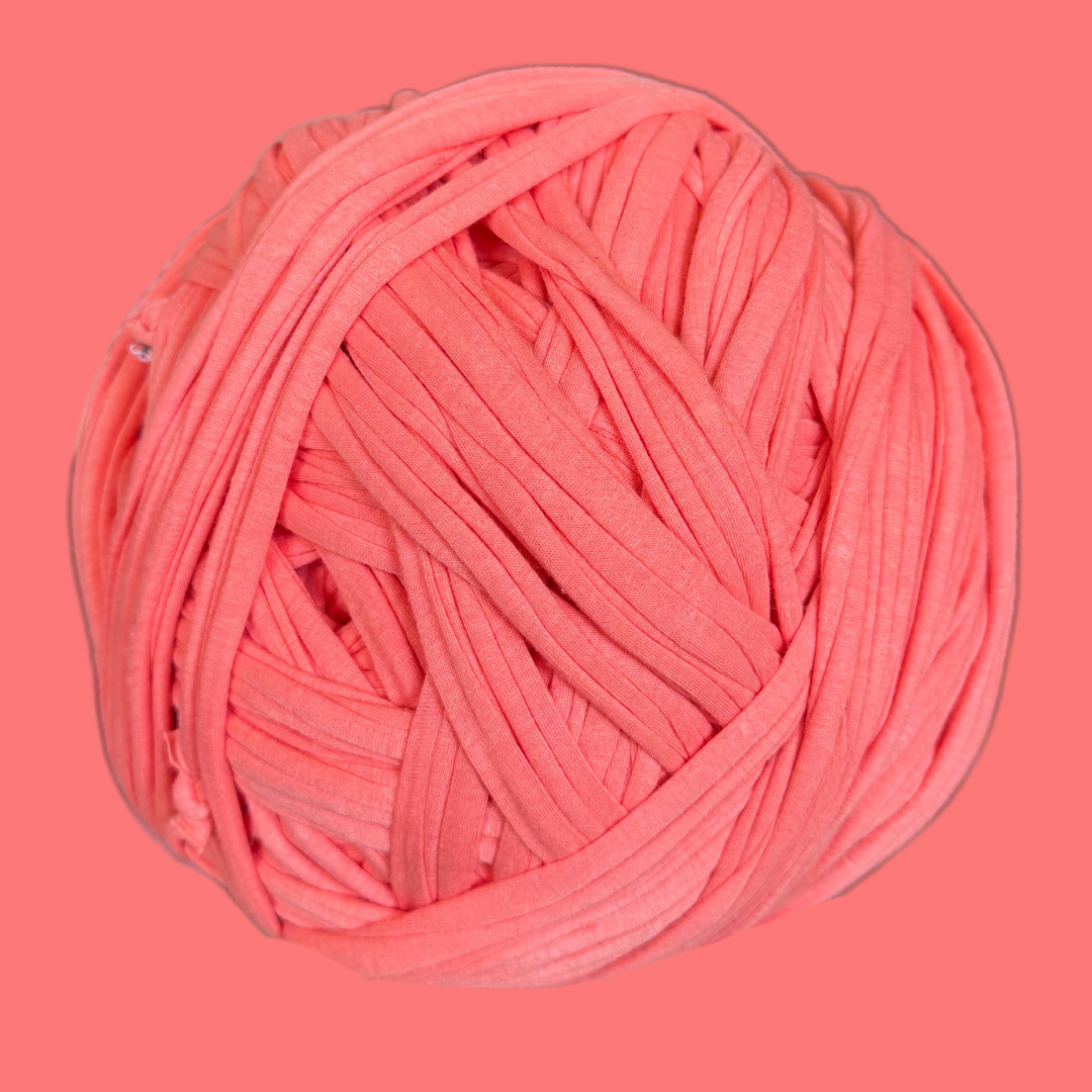 a ball of pink yarn on a pink background