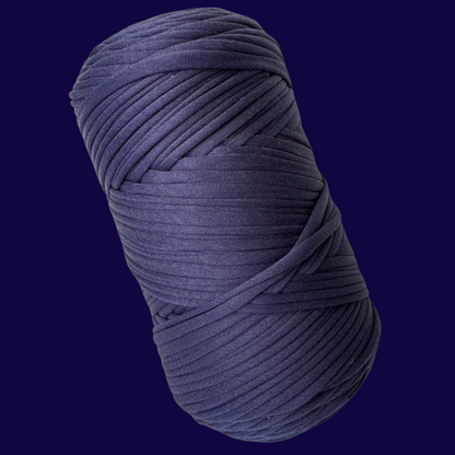 a roll of blue yarn on a black background