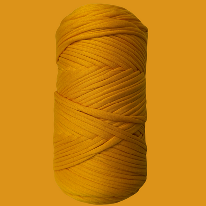 a yellow ball of yarn on a yellow background
