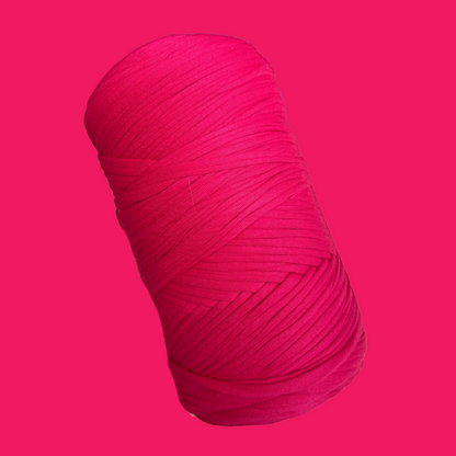 a pink ball of yarn on a pink background