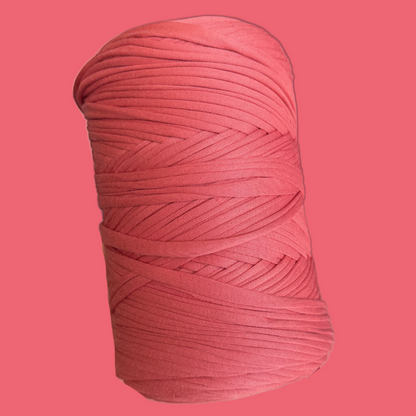 a ball of pink yarn on a pink background