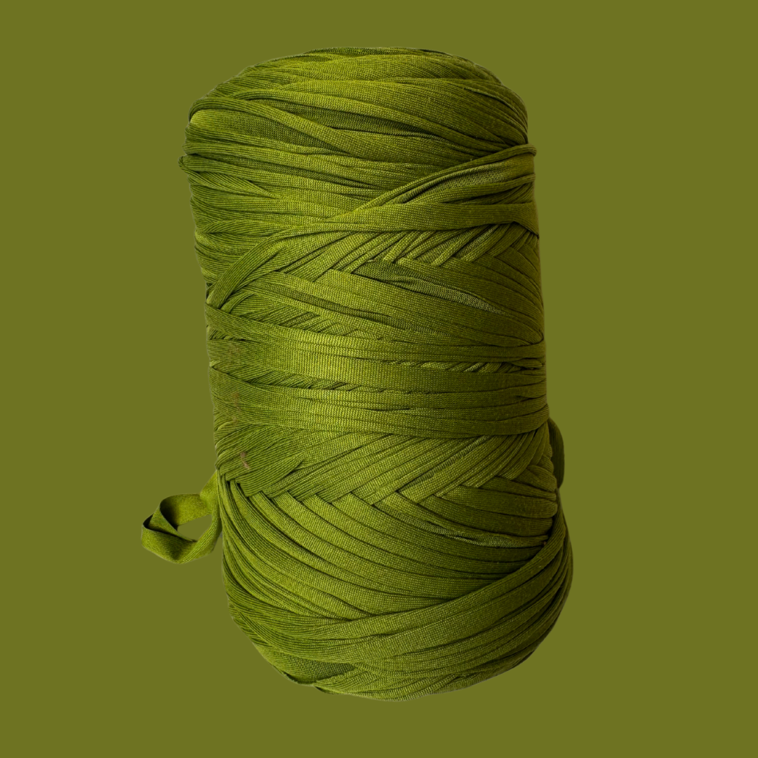 a spool of green thread on a green background
