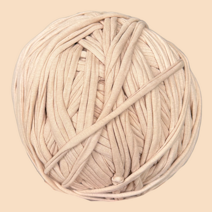 a ball of white yarn on a beige background