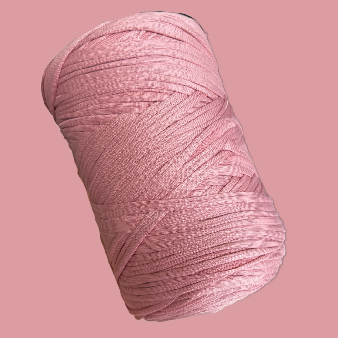 a ball of pink yarn on a pink background