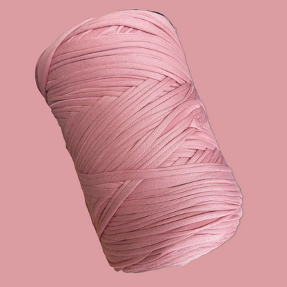 a ball of pink yarn on a pink background
