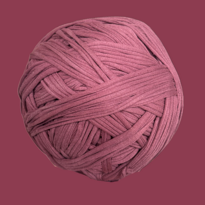 a ball of pink yarn on a pink background
