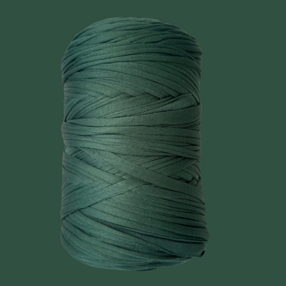 a spool of green thread on a green background