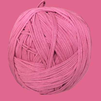 a ball of pink yarn on a pink background